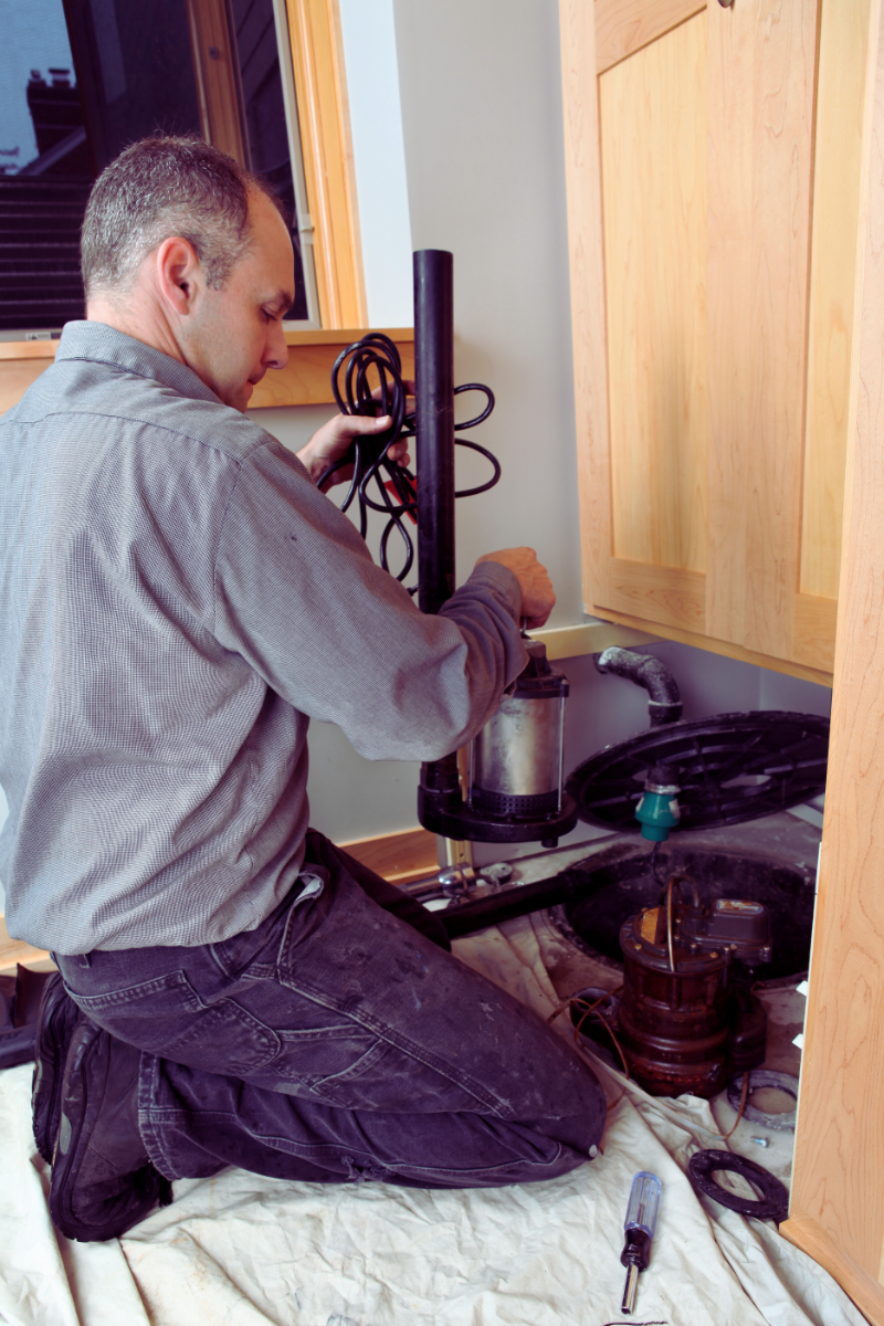plumber fixing sump pump thats making loud noises
