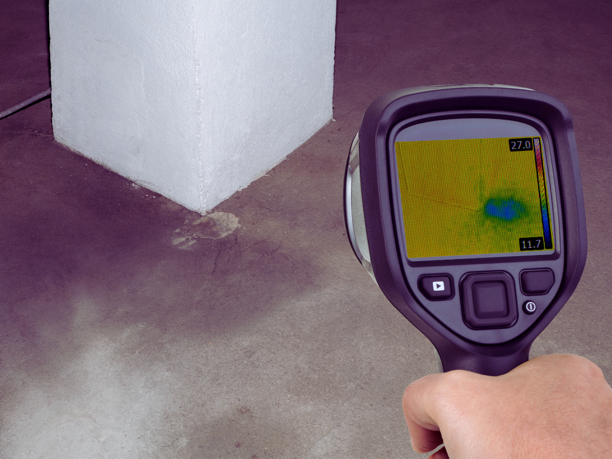 Plumber using thermal imaging to detect hidden leak
